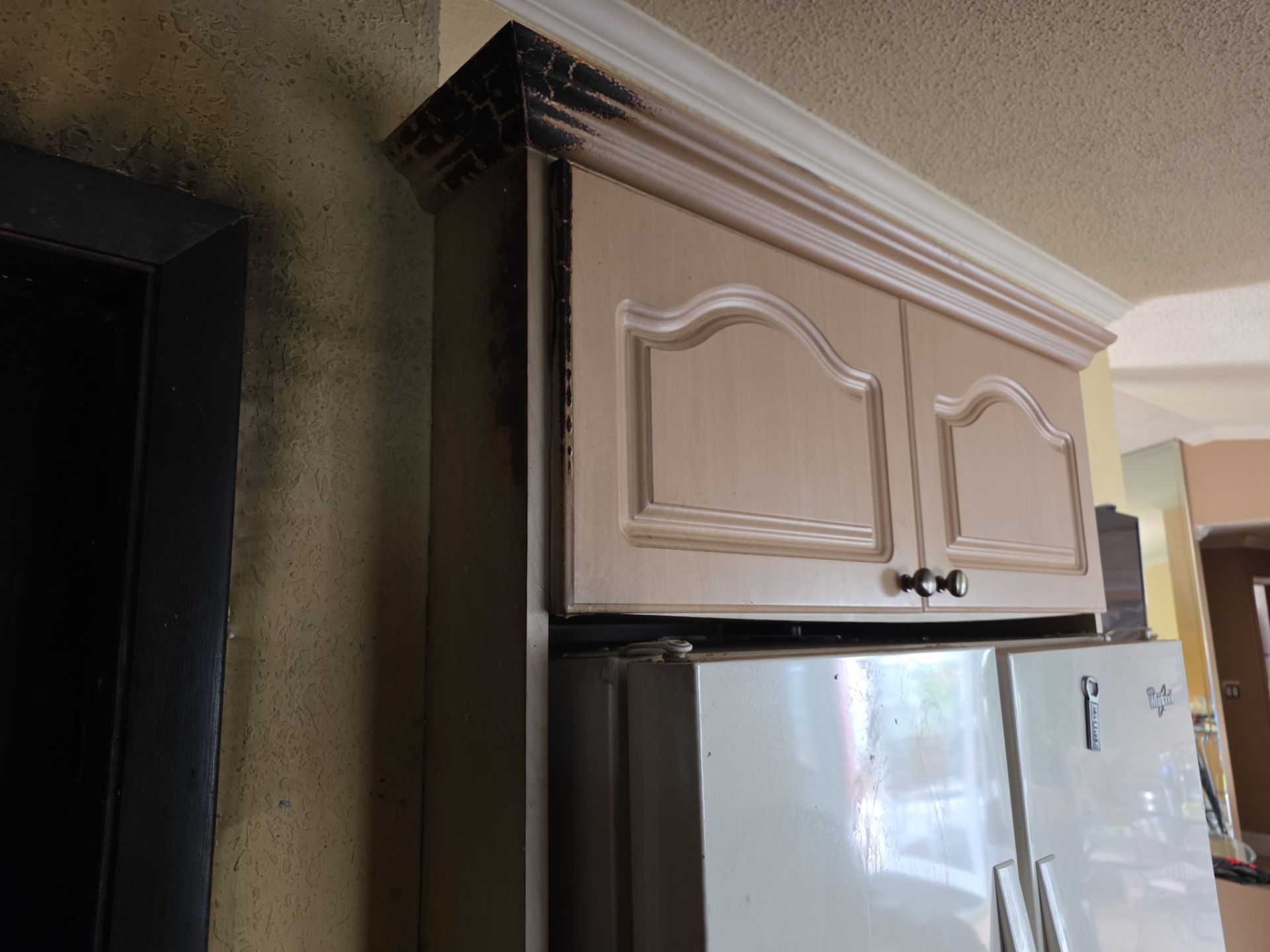 Smoke damage and charring on walls and doorframe